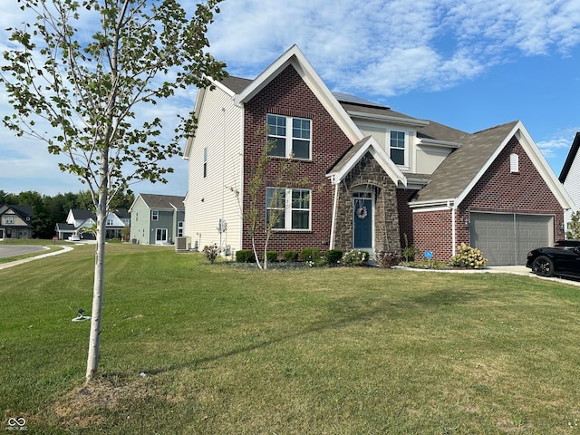 view of front of house featuring cooling unit, a front yard, and a garage