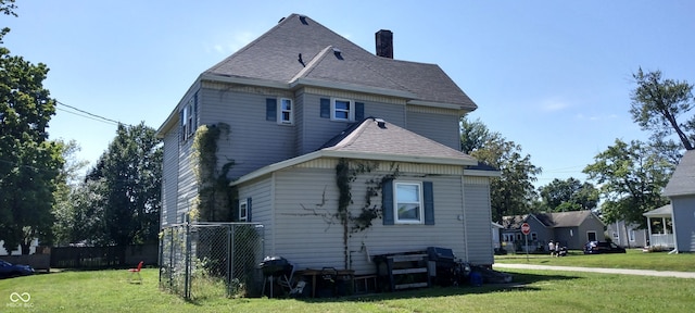 rear view of house with a yard