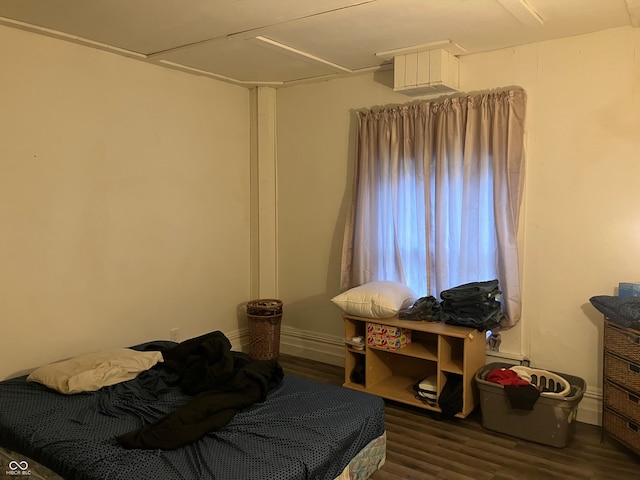 bedroom with dark hardwood / wood-style floors