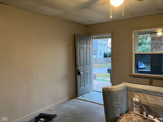 foyer entrance with ceiling fan and light wood-type flooring