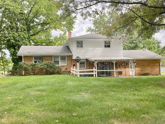 rear view of property featuring a yard