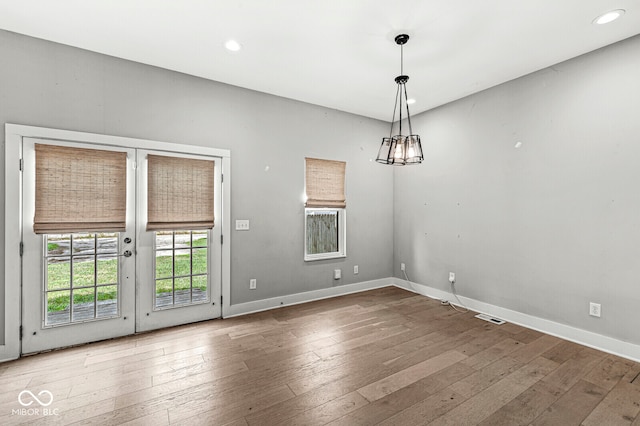 unfurnished room with french doors and wood-type flooring