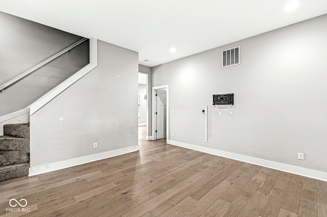 basement featuring hardwood / wood-style floors