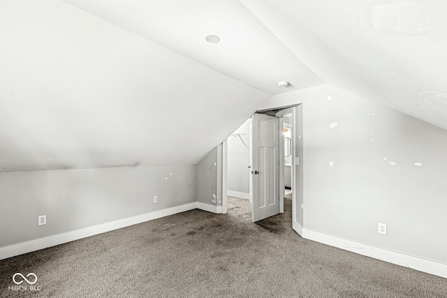 bonus room featuring carpet and vaulted ceiling