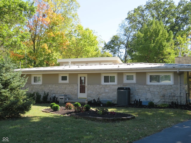 back of house with a yard and central AC