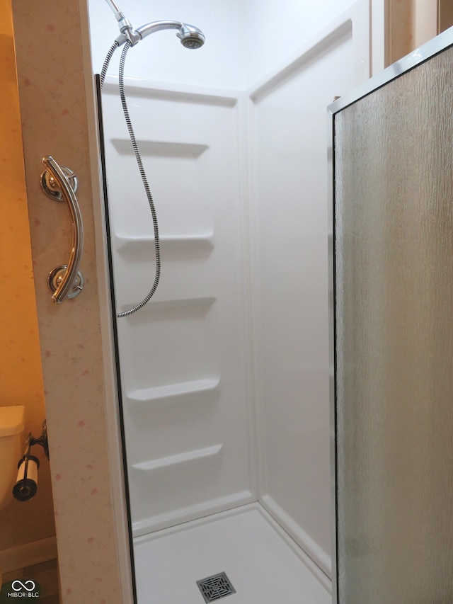 bathroom with visible vents, a stall shower, and toilet