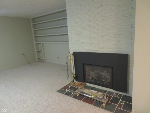 room details featuring carpet flooring, a fireplace, and built in shelves