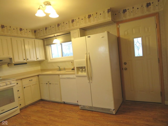 kitchen featuring sink, extractor fan, white appliances, white cabinets, and light wood-type flooring