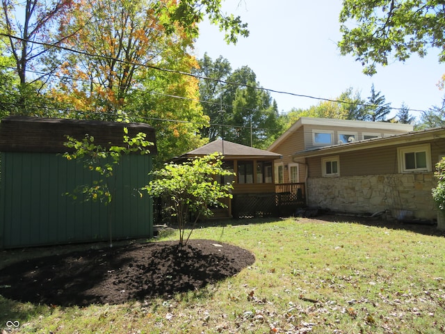 view of yard with a storage unit, an outdoor structure, and a sunroom