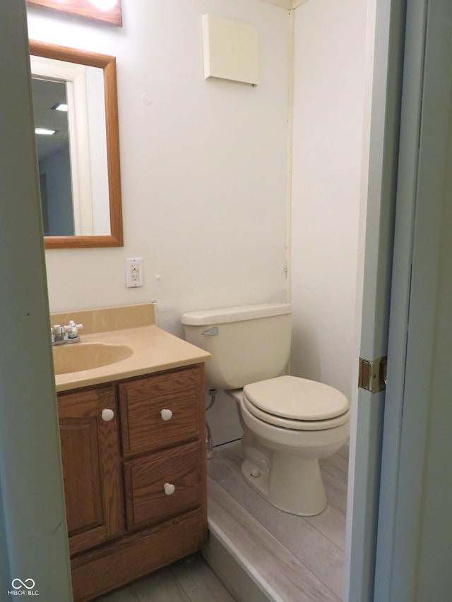 half bathroom featuring toilet and vanity