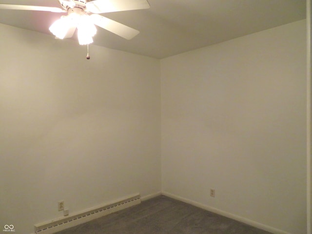 spare room with a baseboard heating unit, baseboards, a ceiling fan, and dark carpet