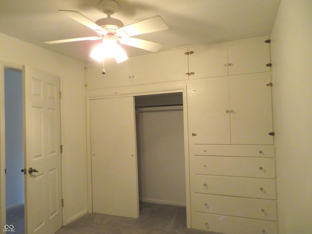 unfurnished bedroom featuring a closet, carpet flooring, and a ceiling fan