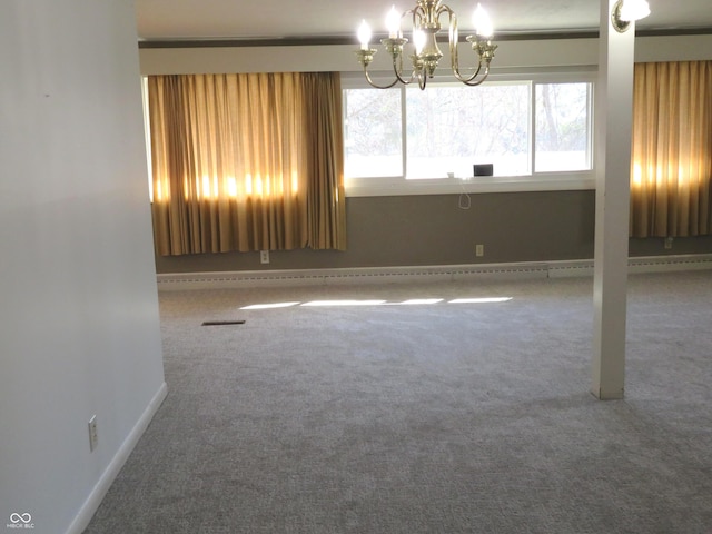 empty room featuring an inviting chandelier, carpet, and baseboards