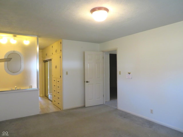 unfurnished room featuring light carpet