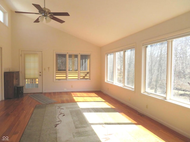 unfurnished sunroom with lofted ceiling and a ceiling fan