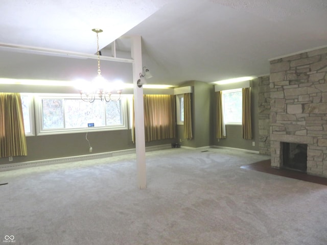 unfurnished living room with a stone fireplace, lofted ceiling, carpet flooring, and baseboards