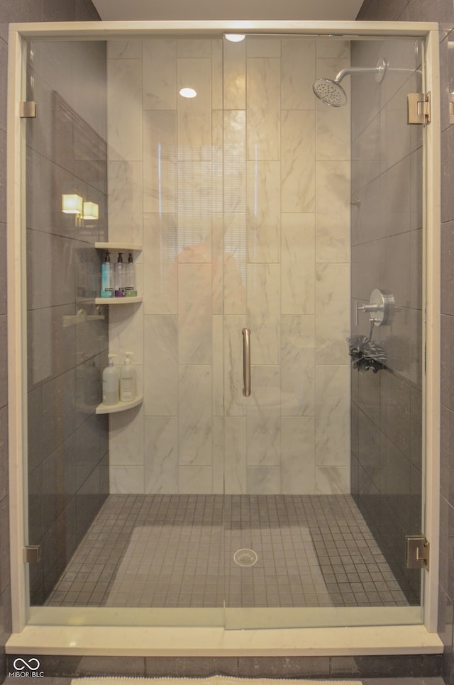 bathroom featuring a shower with shower door