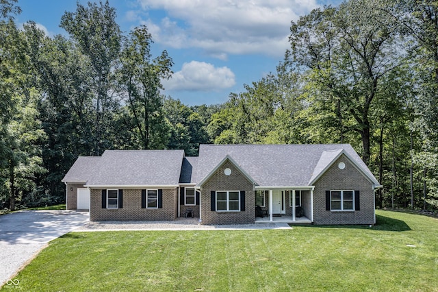 ranch-style house with a porch, a shingled roof, brick siding, concrete driveway, and a front lawn