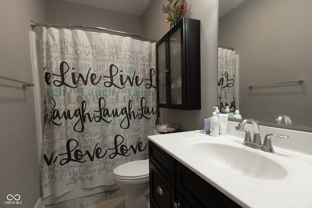 bathroom featuring a shower with curtain, toilet, and vanity