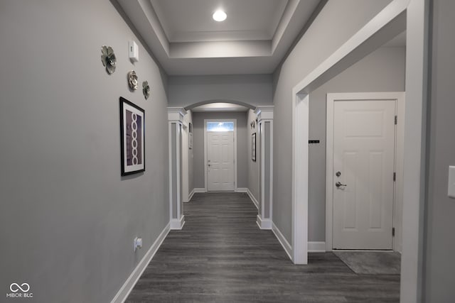 hallway featuring dark wood-type flooring and a raised ceiling