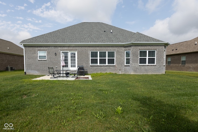 back of property featuring central AC unit, a yard, and a patio