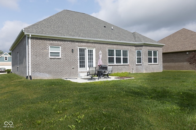 back of property featuring a yard and a patio area