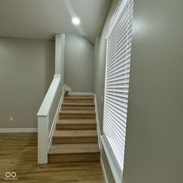 staircase with wood-type flooring