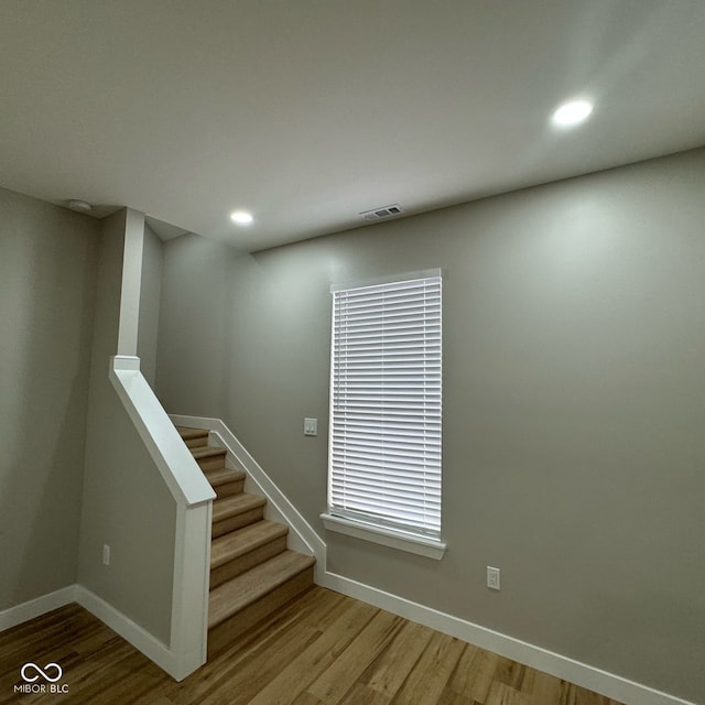 stairs featuring hardwood / wood-style flooring