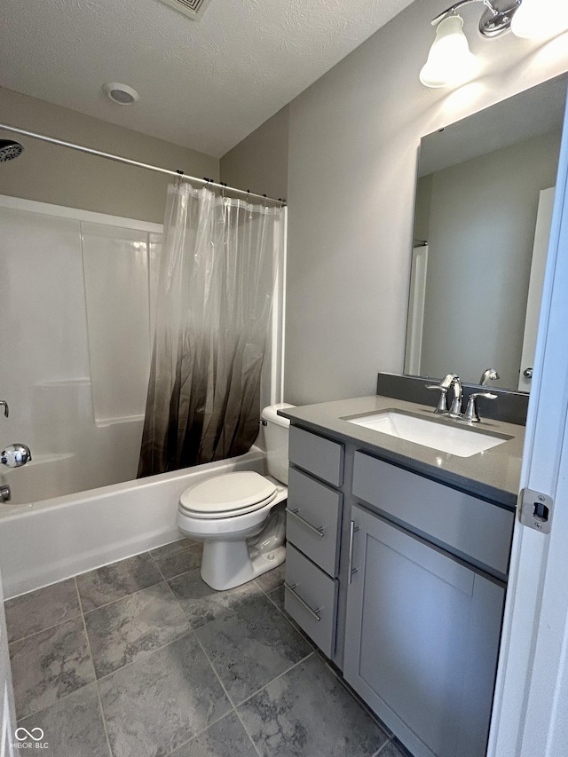 full bathroom featuring vanity, toilet, a textured ceiling, and shower / tub combo with curtain