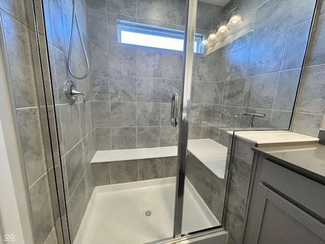 bathroom featuring a shower with shower door and tile walls