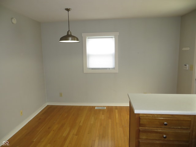 unfurnished dining area featuring light hardwood / wood-style floors