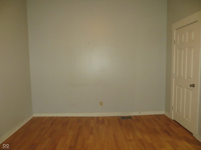 empty room with hardwood / wood-style floors