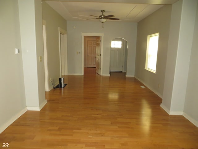 foyer entrance with ceiling fan and light hardwood / wood-style flooring