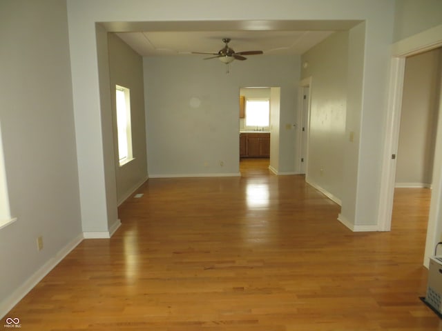 unfurnished room with ceiling fan and light wood-type flooring