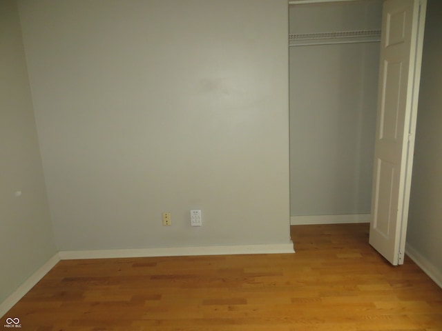 unfurnished bedroom with a closet and light hardwood / wood-style flooring