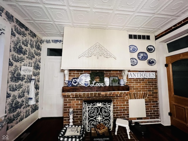 living area with a brick fireplace and an ornate ceiling