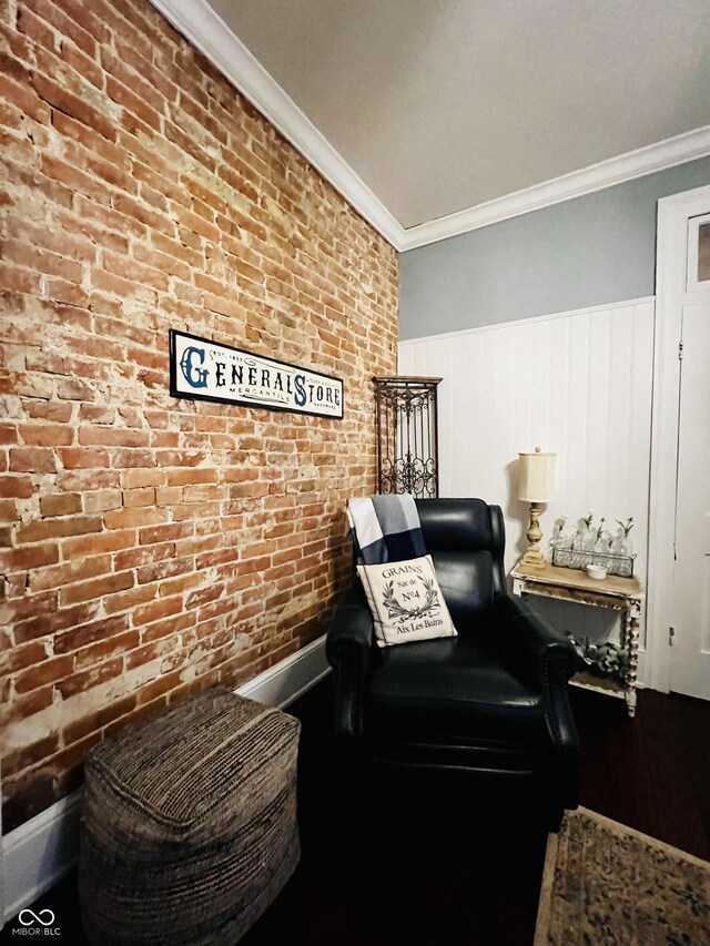 sitting room with brick wall and ornamental molding