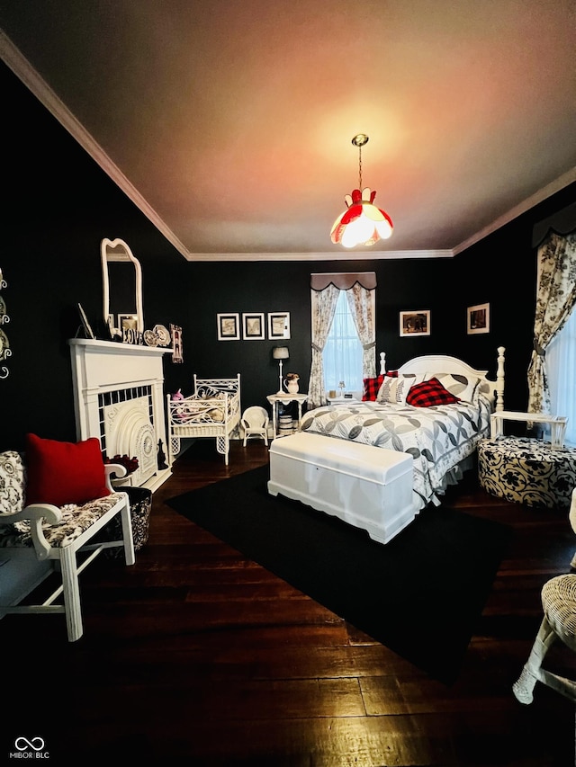 bedroom with wood finished floors, crown molding, and a tile fireplace