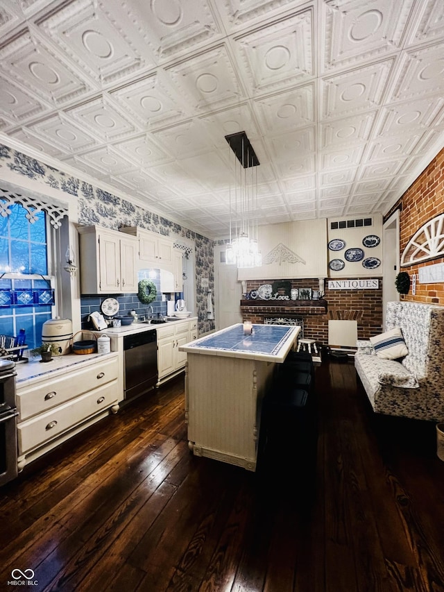 kitchen featuring white cabinetry, dishwashing machine, dark wood finished floors, and an ornate ceiling