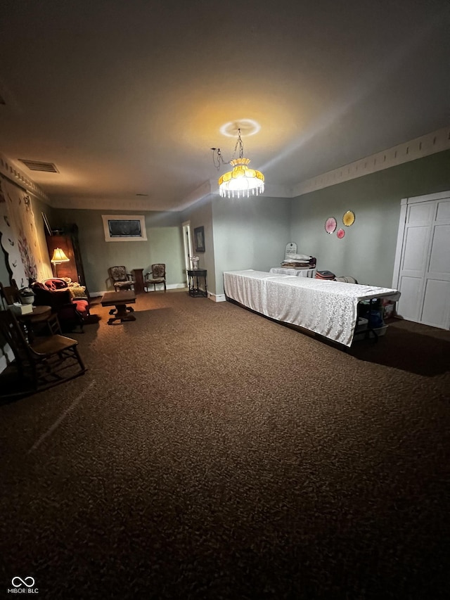 carpeted bedroom featuring baseboards and visible vents