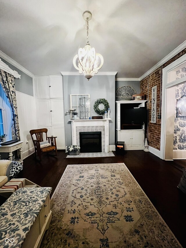 living area featuring dark wood-style flooring, brick wall, and crown molding