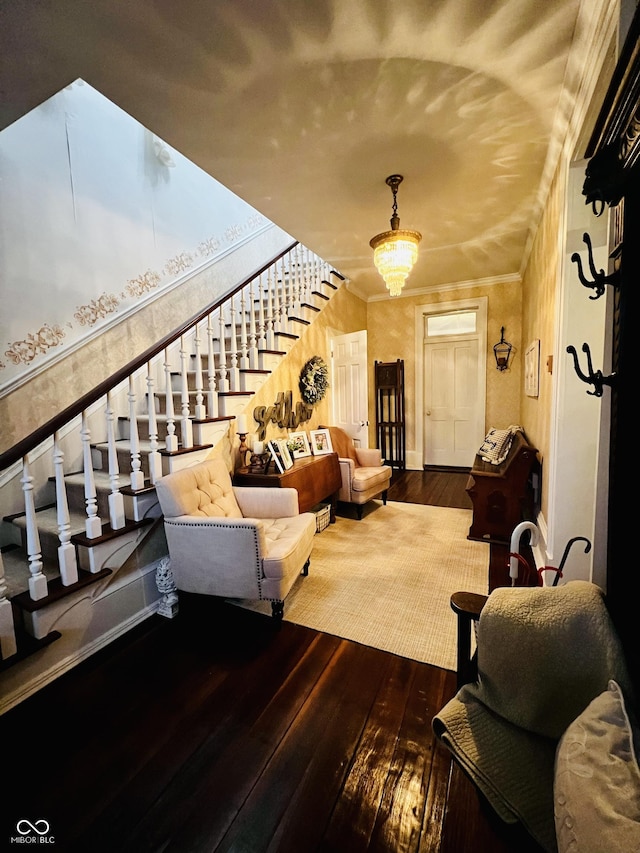 living area with hardwood / wood-style floors, stairs, and crown molding