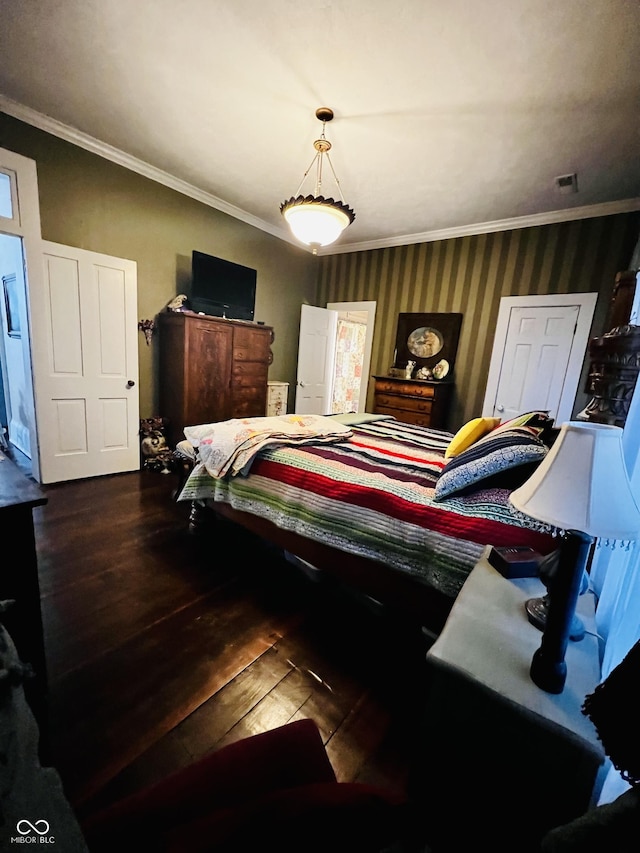 bedroom featuring wallpapered walls, crown molding, and wood finished floors