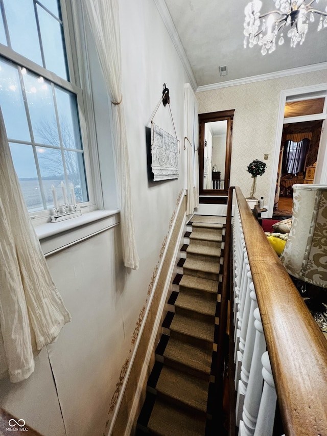 stairway with visible vents, a notable chandelier, and ornamental molding