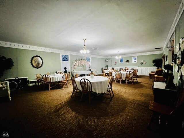 carpeted dining space with a notable chandelier