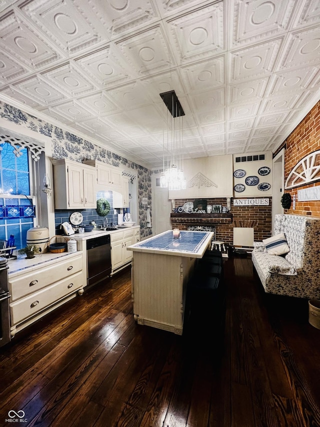 kitchen featuring an ornate ceiling, dark wood finished floors, white cabinets, light countertops, and dishwashing machine