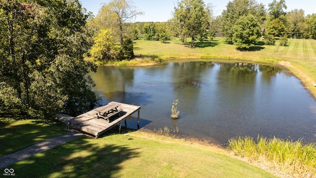 dock area featuring a water view and a lawn