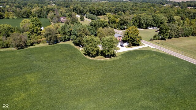 bird's eye view with a wooded view