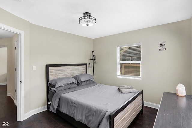 bedroom with dark wood-type flooring