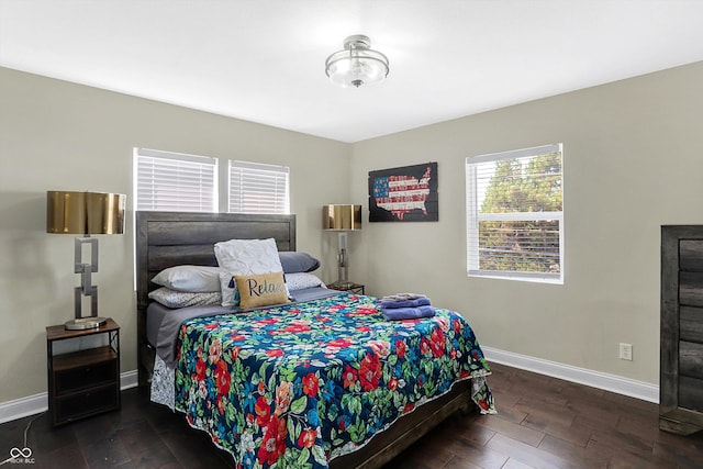 bedroom featuring wood finished floors and baseboards